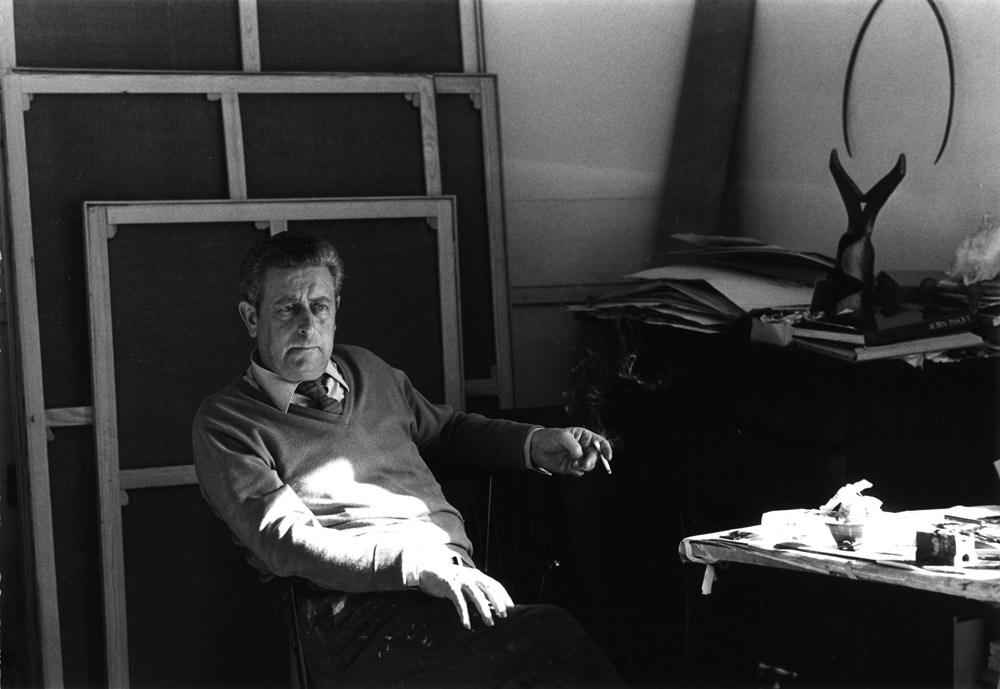 Louis Van Lint in his studio, with two tools of his collection in the background.